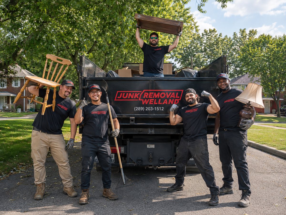 The Junk Removal Welland crew posing with the truck, holding a chair, rake, table, and lamp